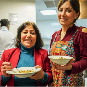 Two mature ladies holding plates