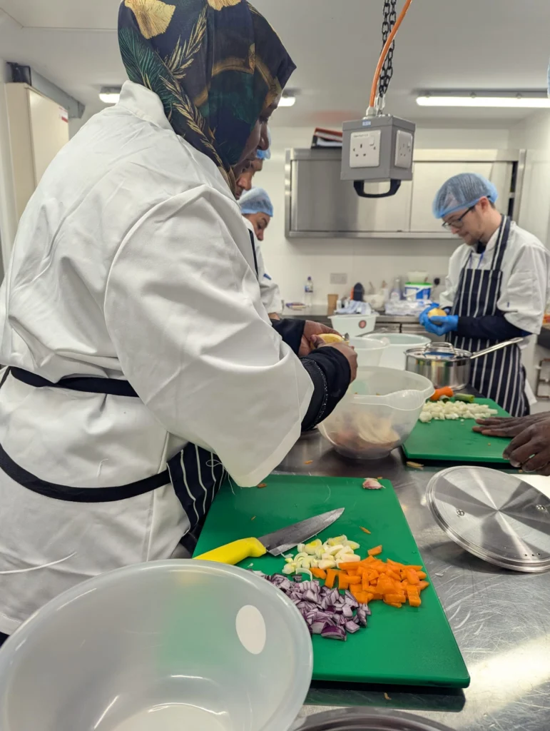 Plateful Cafe students chopping vegetables